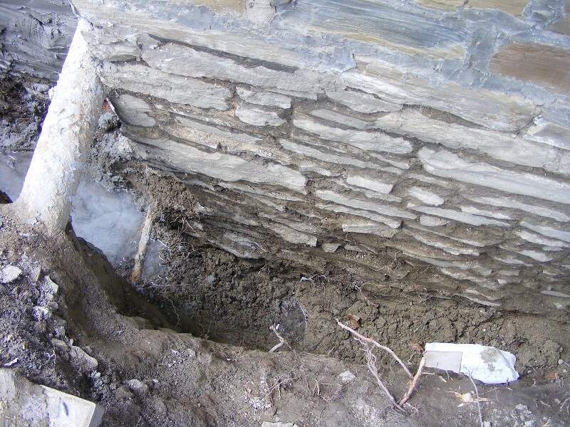foundation wall with cracks and holes