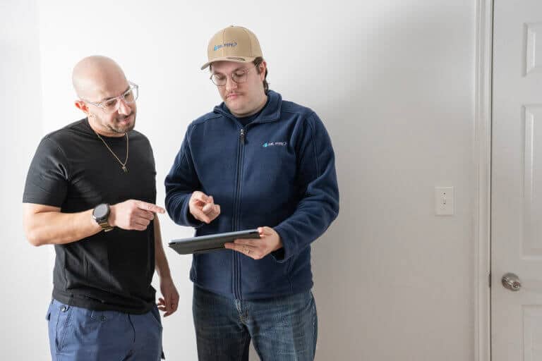 Dr. Pipe technician, talking with a client for tankless water heater service in Ottawa