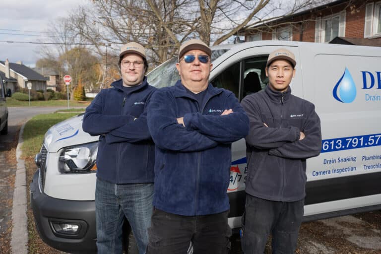 Three Dr. Pipe technicians standing in front of a service van in Ottawa