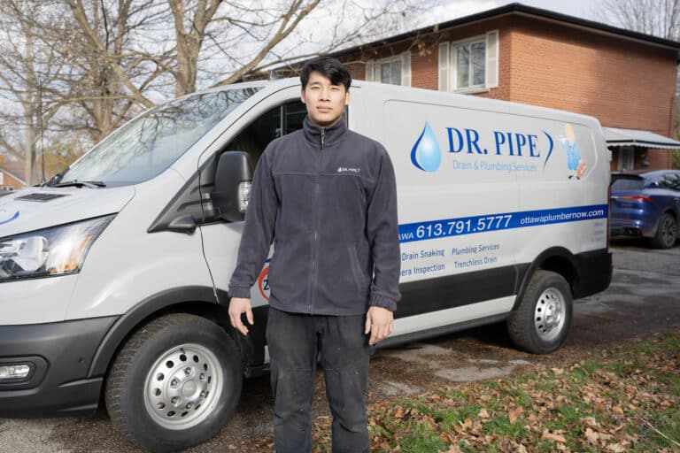 Dr. Pipe technician in front of a service van for low water pressure repair in Ottawa
