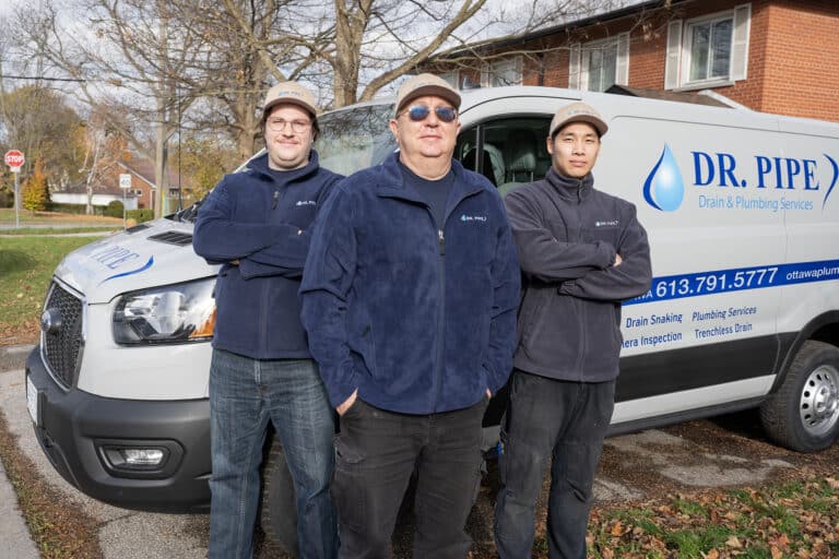 Dr. Pipe technicians in front of a service van for running a new water main in Ottawa