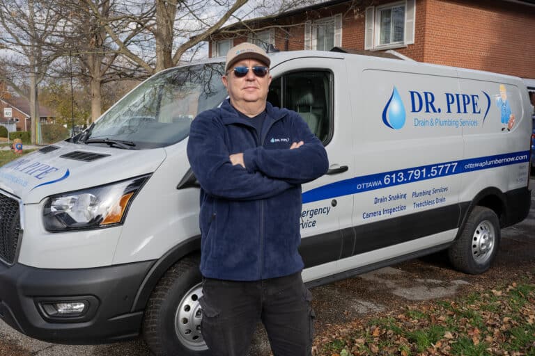 Dr. Pipe technician in front of a service van for sewer camera inspection in Ottawa