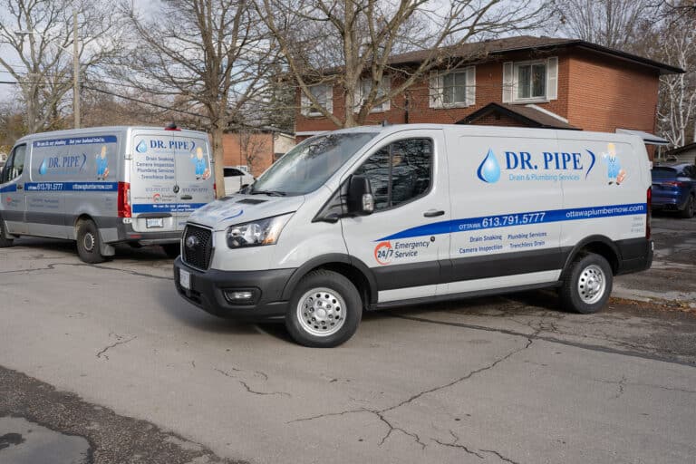 Two Dr. Pipe service vans parked on a residential street in Ottawa